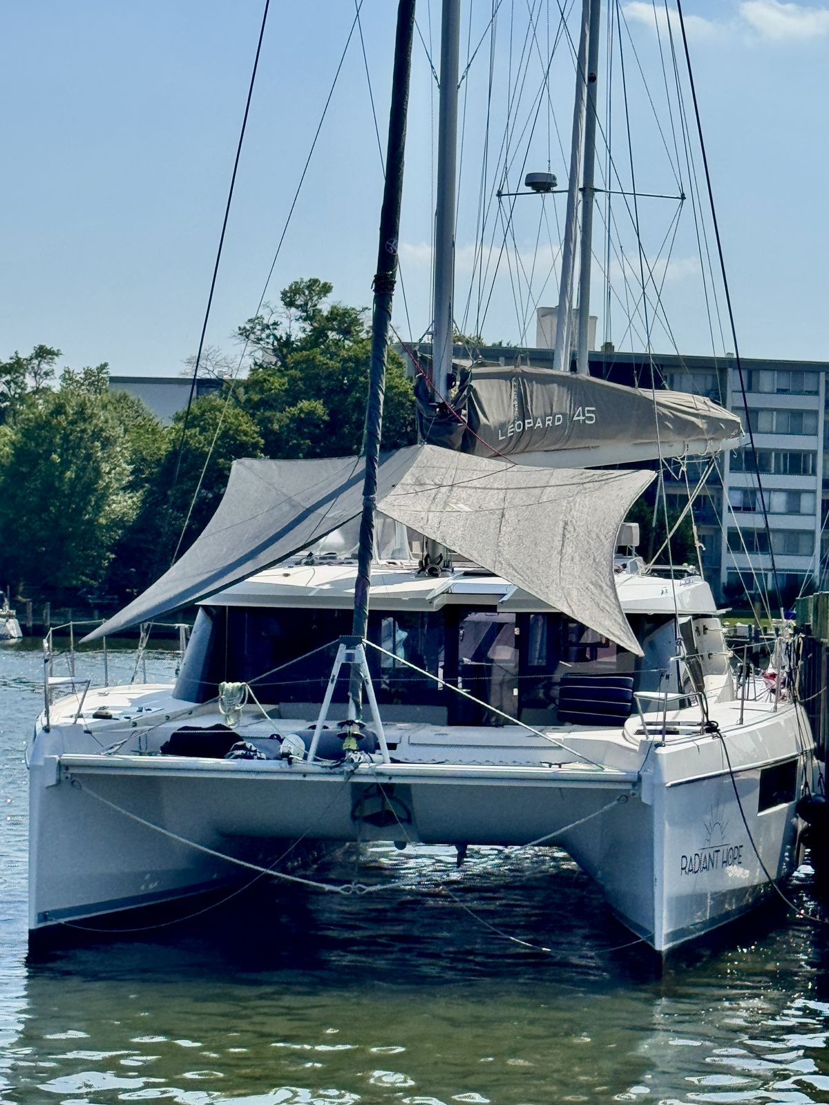Bow-on at dock with gray Sunrise sun shade over forward cockpit