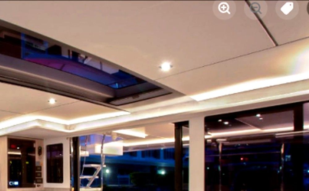Night saloon looking aft with warm LED cove lighting and open doors